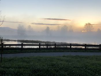 Scenic view of field against sky during sunset