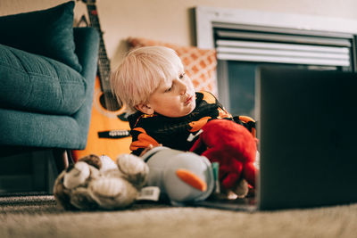 Young boy video conferencing with class on computer