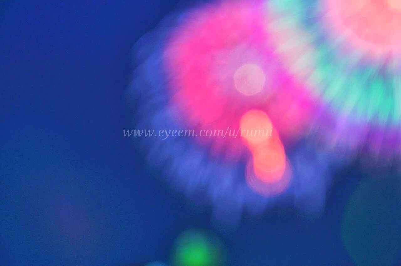 illuminated, night, multi colored, low angle view, glowing, light - natural phenomenon, arts culture and entertainment, blurred motion, lighting equipment, long exposure, blue, motion, speed, defocused, sky, red, abstract, outdoors, no people, lens flare