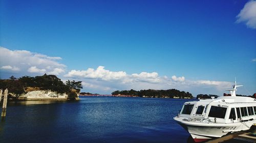 Boats in sea against blue sky