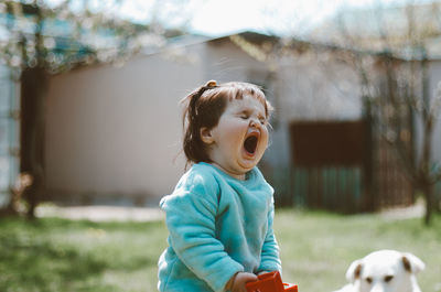 Boy looking away while standing outdoors