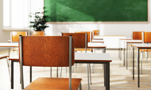 Empty chairs and table in building