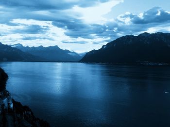 Scenic view of lake and mountains against sky