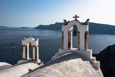 Built structure by sea against clear sky