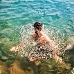 High angle view of boy swimming in pool