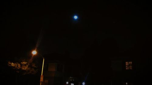 Low angle view of illuminated lights at night