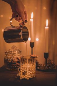 Close-up of illuminated tea light candles on table