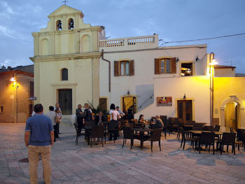 People on table against built structure