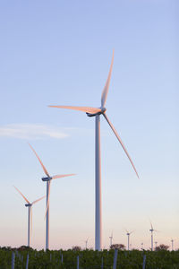 View of wind turbines at sunset