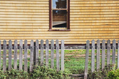 Old picket fence and wall of timber cottage