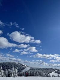 Scenic view of snowcapped mountains against blue sky