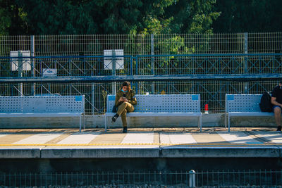 Man playing soccer on railing