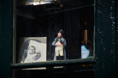 Portrait of woman standing by window