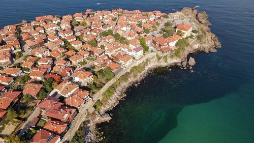 High angle view of townscape by sea