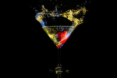 Close-up of wine glass against black background