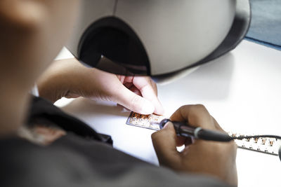 Cropped image of technician making circuit board in industry