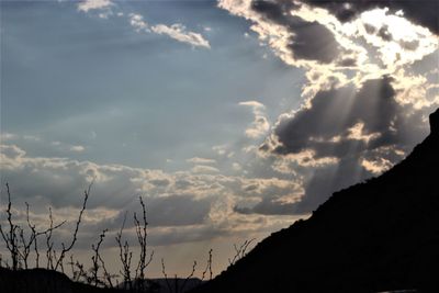 Low angle view of silhouette mountain against dramatic sky