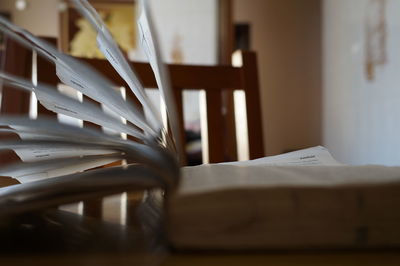 Close-up of open book on table at home