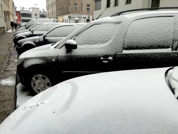 Close-up of cars on street in city