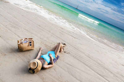 High angle view of woman lying on beach