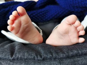 Low section of baby feet on bed