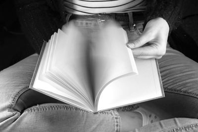 Close-up of hand holding book