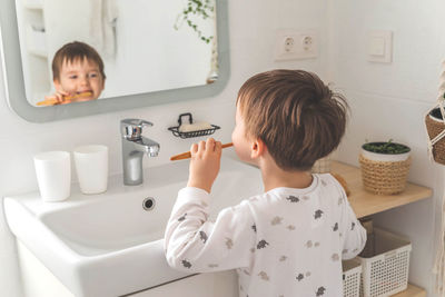 Side view of mother and daughter in bathroom