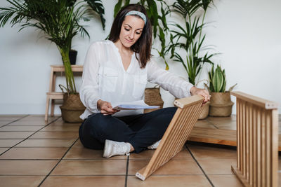 Woman repairing furniture at home