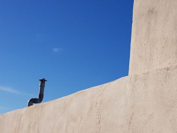 Low angle view of building against clear blue sky