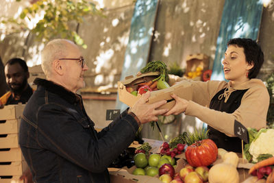 Side view of woman holding food at home