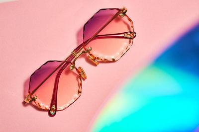 Close-up of decoration on table against pink background