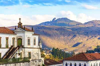 Houses and mountains against sky