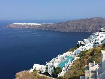 High angle view of sea and mountains against clear sky