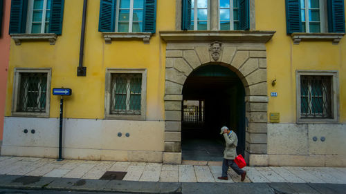 Full length of woman standing against building