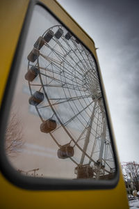 Low angle view of ferris wheel against sky