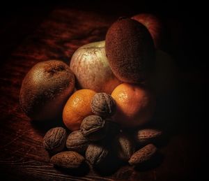 Close-up of fruits on table against black background