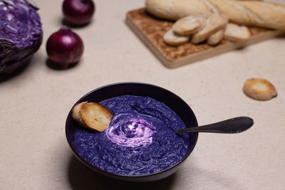 Food photo with bright red cabbage cream soup. purple food