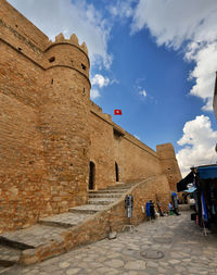 Low angle view of historical building against cloudy sky