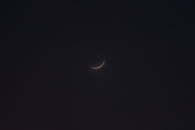 Low angle view of moon against sky at night