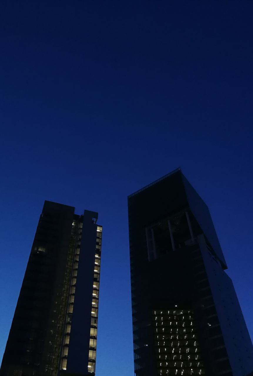 sky, low angle view, blue, architecture, building exterior, built structure, clear sky, building, copy space, office building exterior, tall - high, no people, skyscraper, nature, modern, city, tower, office, dusk, night, outdoors, financial district