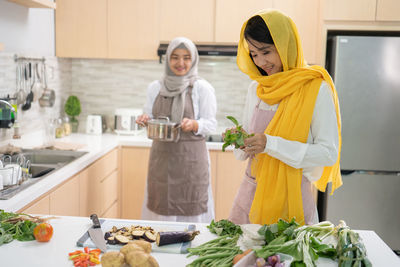 Full length of woman standing at table at home