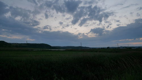 Scenic view of field against sky during sunset