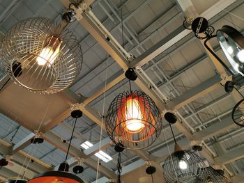 Low angle view of illuminated chandelier hanging from ceiling