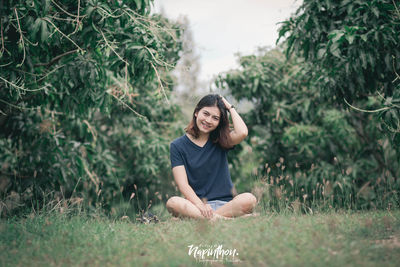 Portrait of a smiling young woman on field