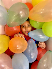 Portrait of boy with colorful balloons