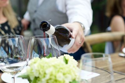 Cropped image of hand pouring wine in glass