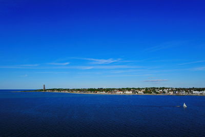 Scenic view of sea against blue sky