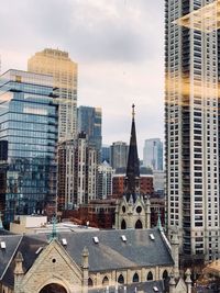 Modern buildings in city against sky