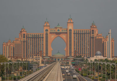 View of railroad tracks against buildings in city