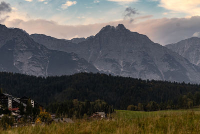 Scenic view of field and mountains against sky